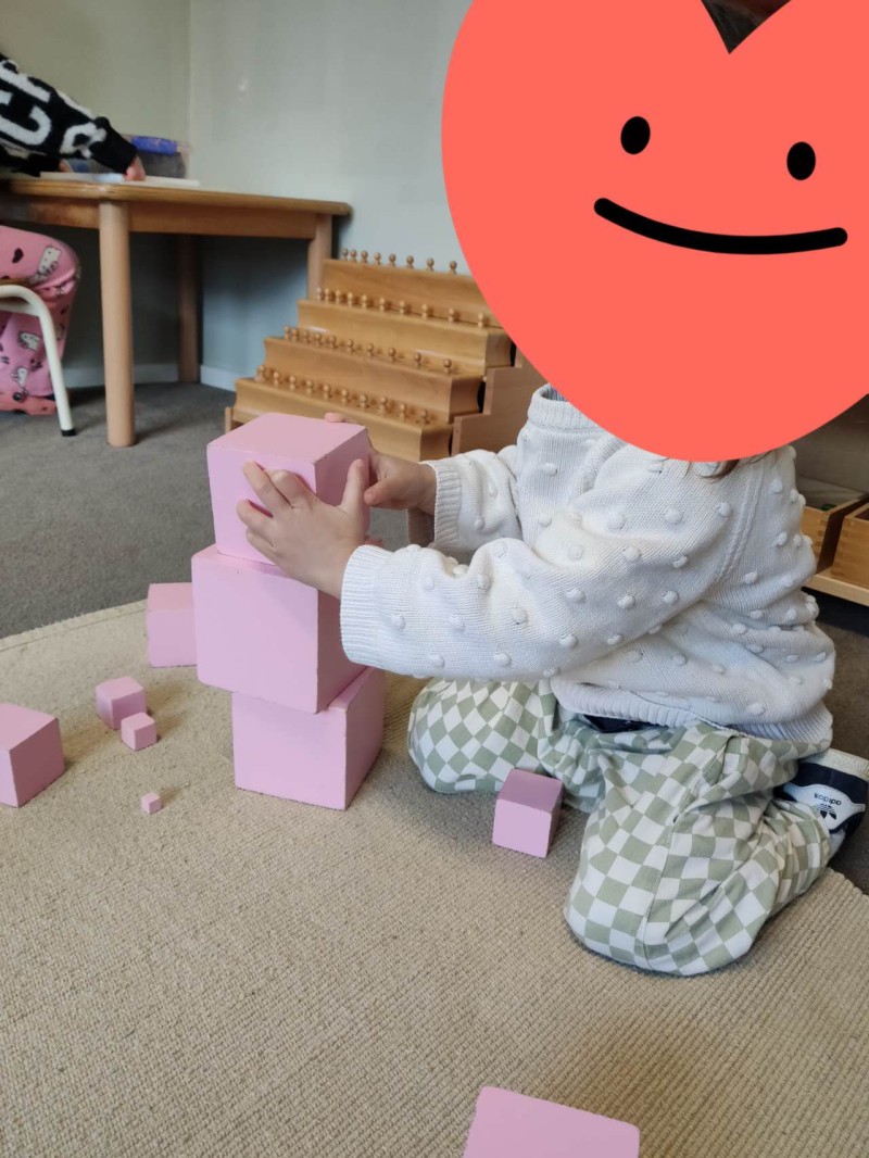 Child exploring the Montessori Roman Arch, developing balance, problem-solving and an understanding of structural design. - Why Sensorial Activities Matter | Montessori Children's House | Montessori Children's House